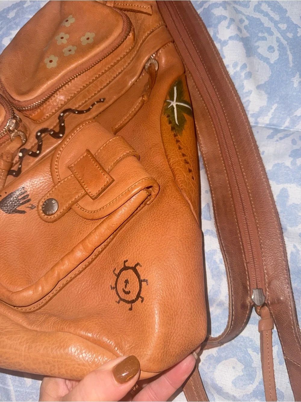 Compact Brown Leather Sling Backpack with Decorative Accents